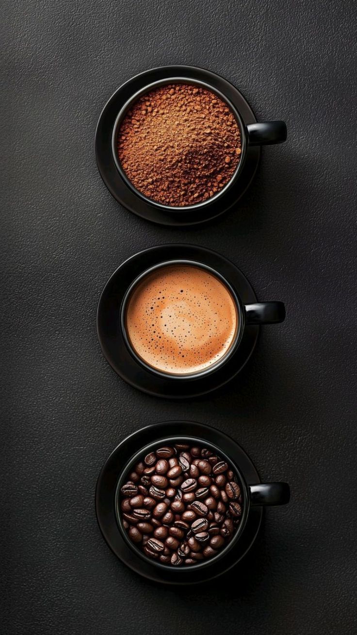 Three cups showing ground coffee, brewed coffee, and whole roasted beans